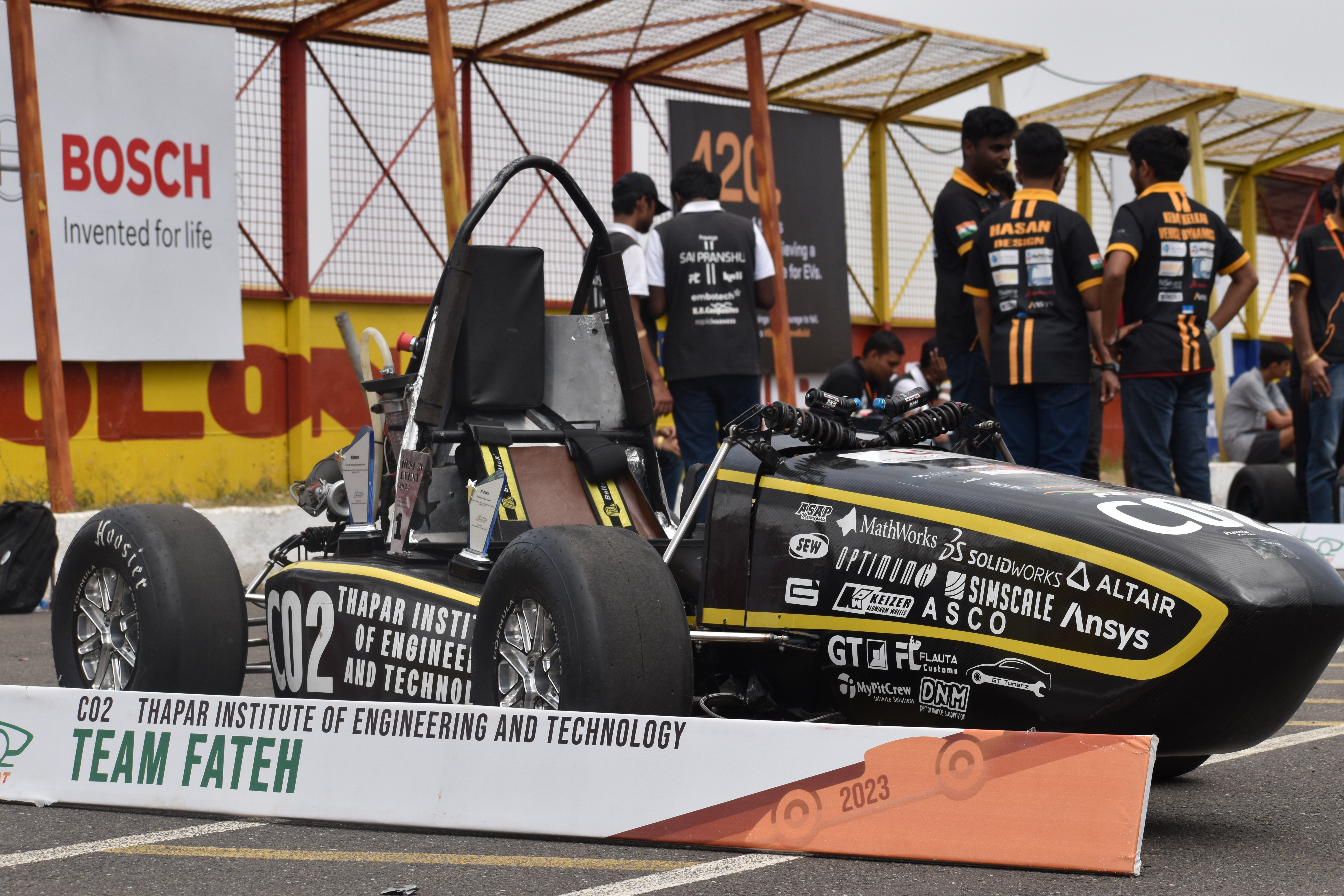 The CO2 car in the pit area at Formula Bharat, front three-quarter view